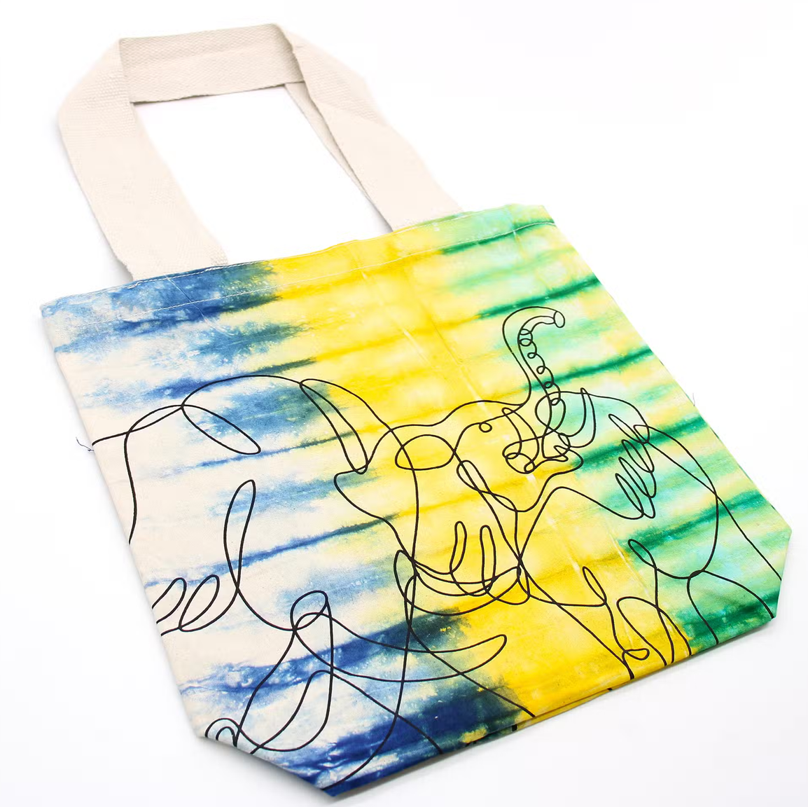 Kleurrijke handgetekende draagtas met blauwe, gele en groene abstracte krabbels op een witte achtergrond