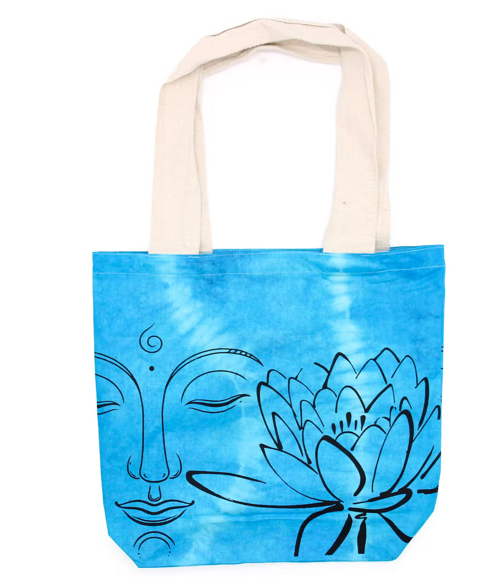 Blauwe draagtas met een zwart lijntekening van een gezicht en lotusbloem, beige handvatten