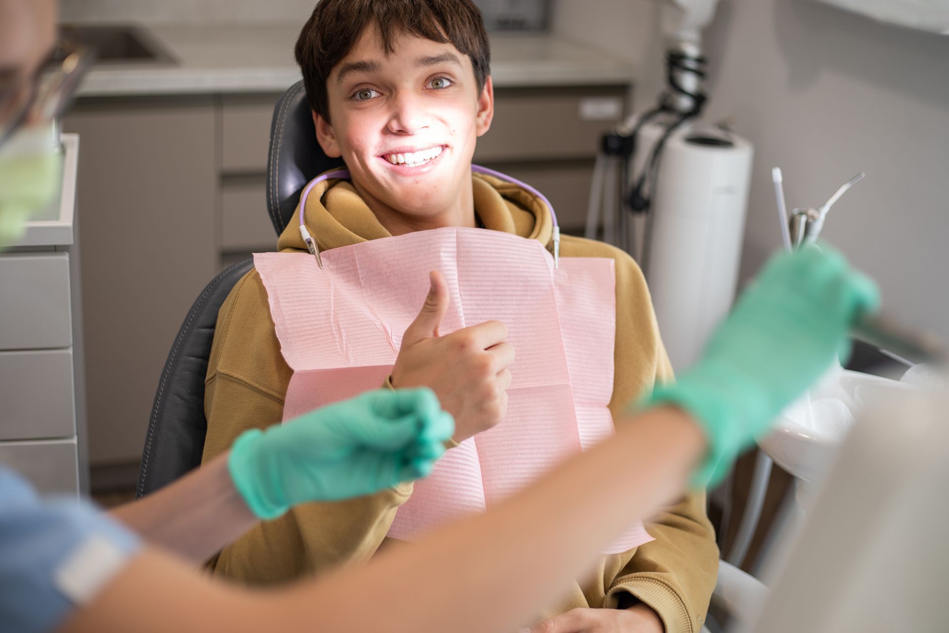 Happy patient in dental treatment chair
