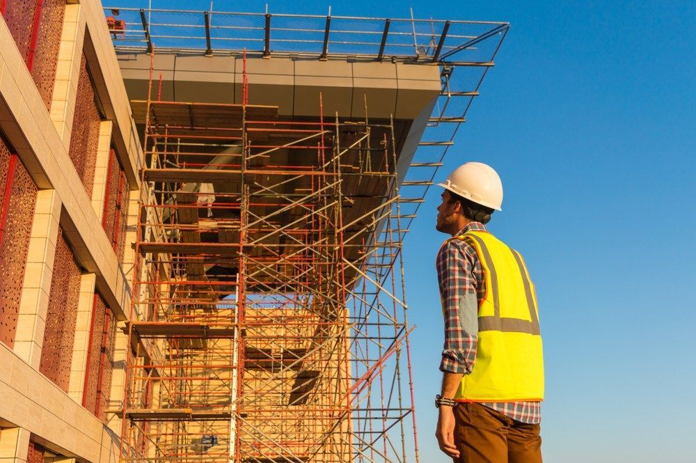 A man is standing on near a scaffolding structure — Fahlstrom Scaffolding Cairns Pty Ltd in Cairns, QLD