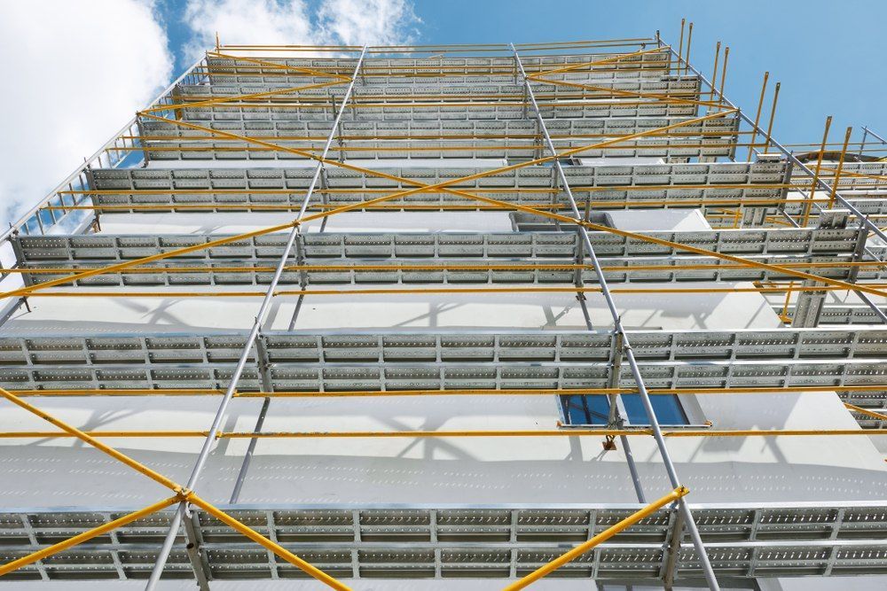 A Large Building Is Being Built With Scaffolding — Fahlstrom Scaffolding Cairns Pty Ltd in Gordonvale, QLD