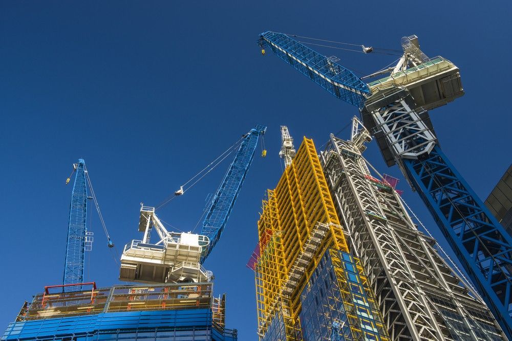 A Building Is Being Built With Cranes — Fahlstrom Scaffolding Cairns Pty Ltd in Gordonvale, QLD