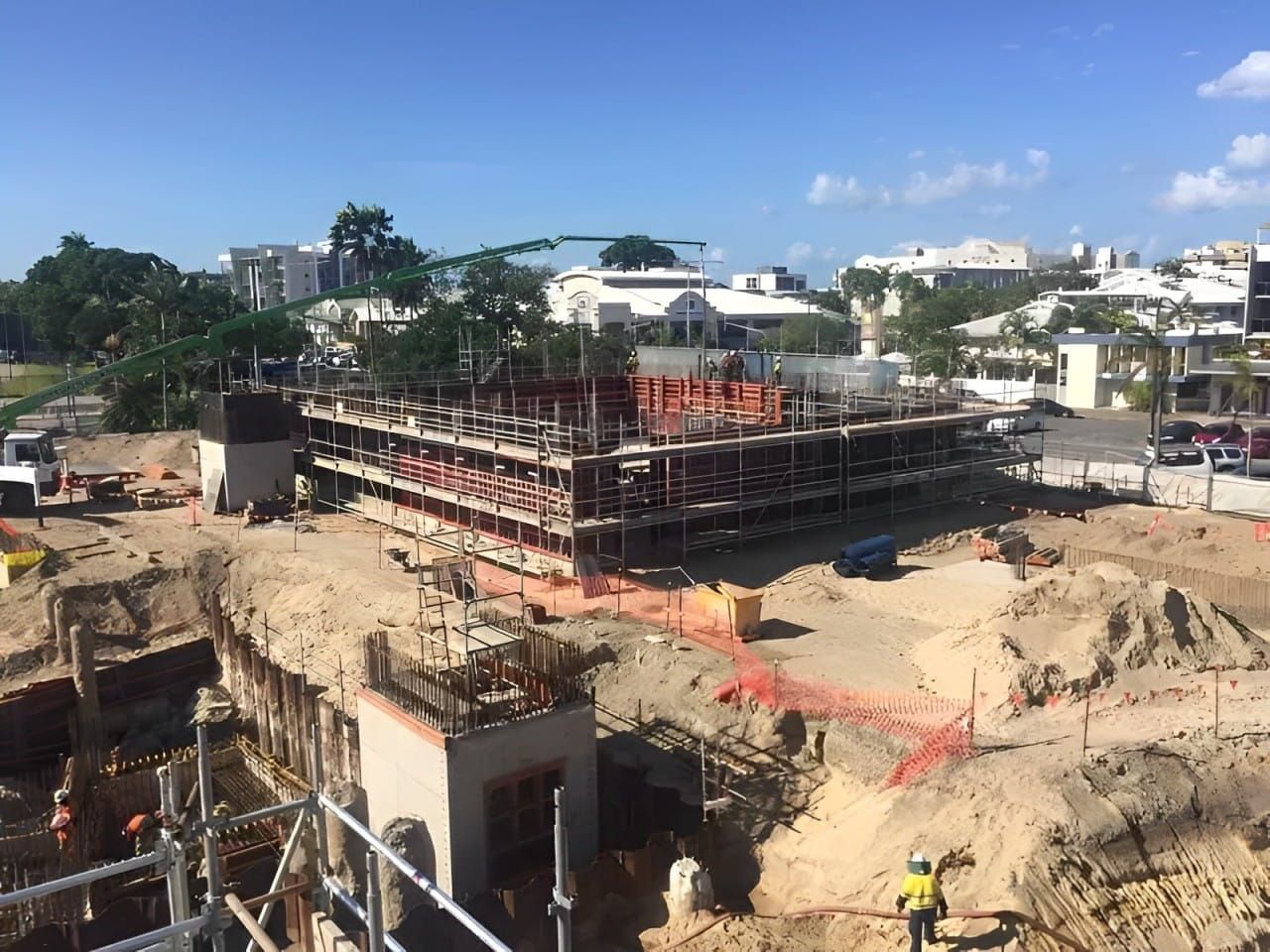 A Large Building Is Being Built In The Middle Of A Dirt Field — Fahlstrom Scaffolding Cairns Pty Ltd in Gordonvale, QLD