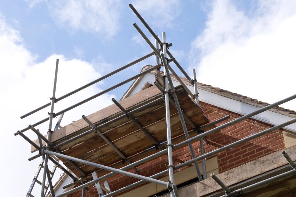 A Large House Is Being Built With Scaffolding Around It — Fahlstrom Scaffolding Cairns Pty Ltd in Cairn, QLD