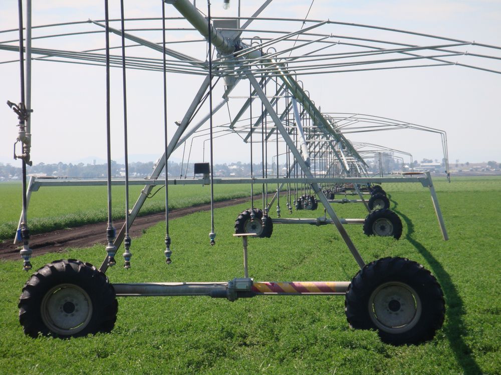 A Row of Irrigation Equipment in a Grassy Field — Stockers & Partridge In Raymond Terrace, NSW