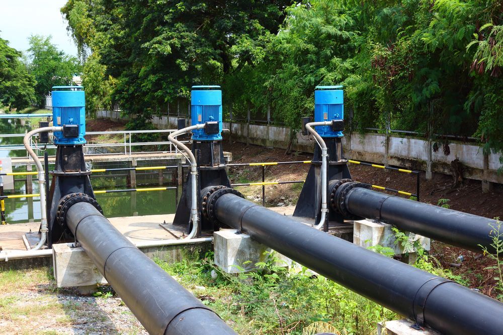 A Row of Black Pipes With Blue Pumps Attached to Them — Stockers & Partridge In Maitland, NSW