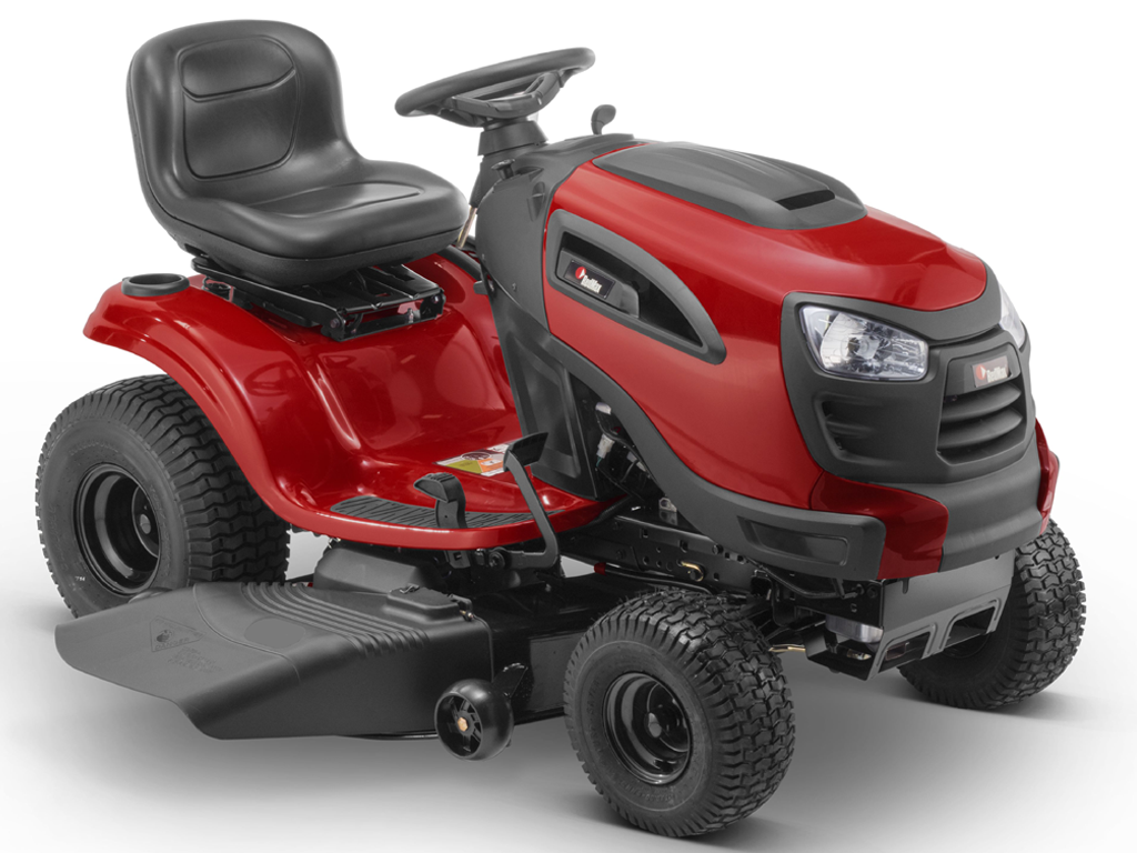 A Person is Riding a Lawn Mower on a Lush Green Field — Stockers & Partridge In Raymond Terrace, NSW