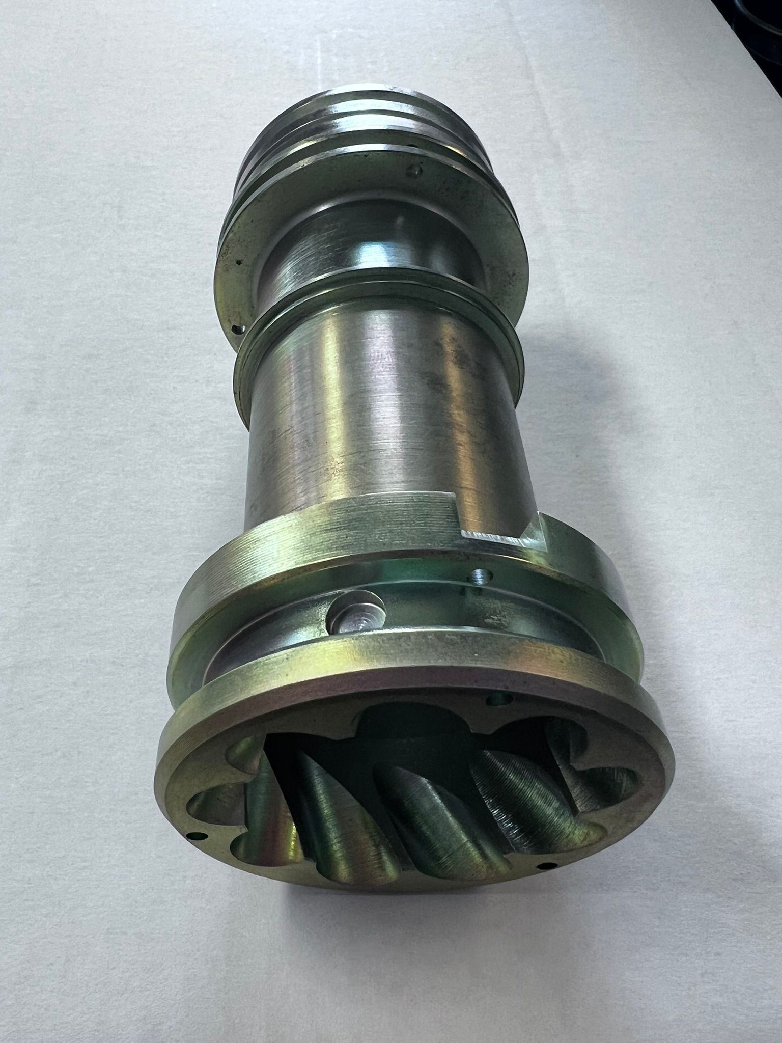 A close up of a metal object on a white surface.