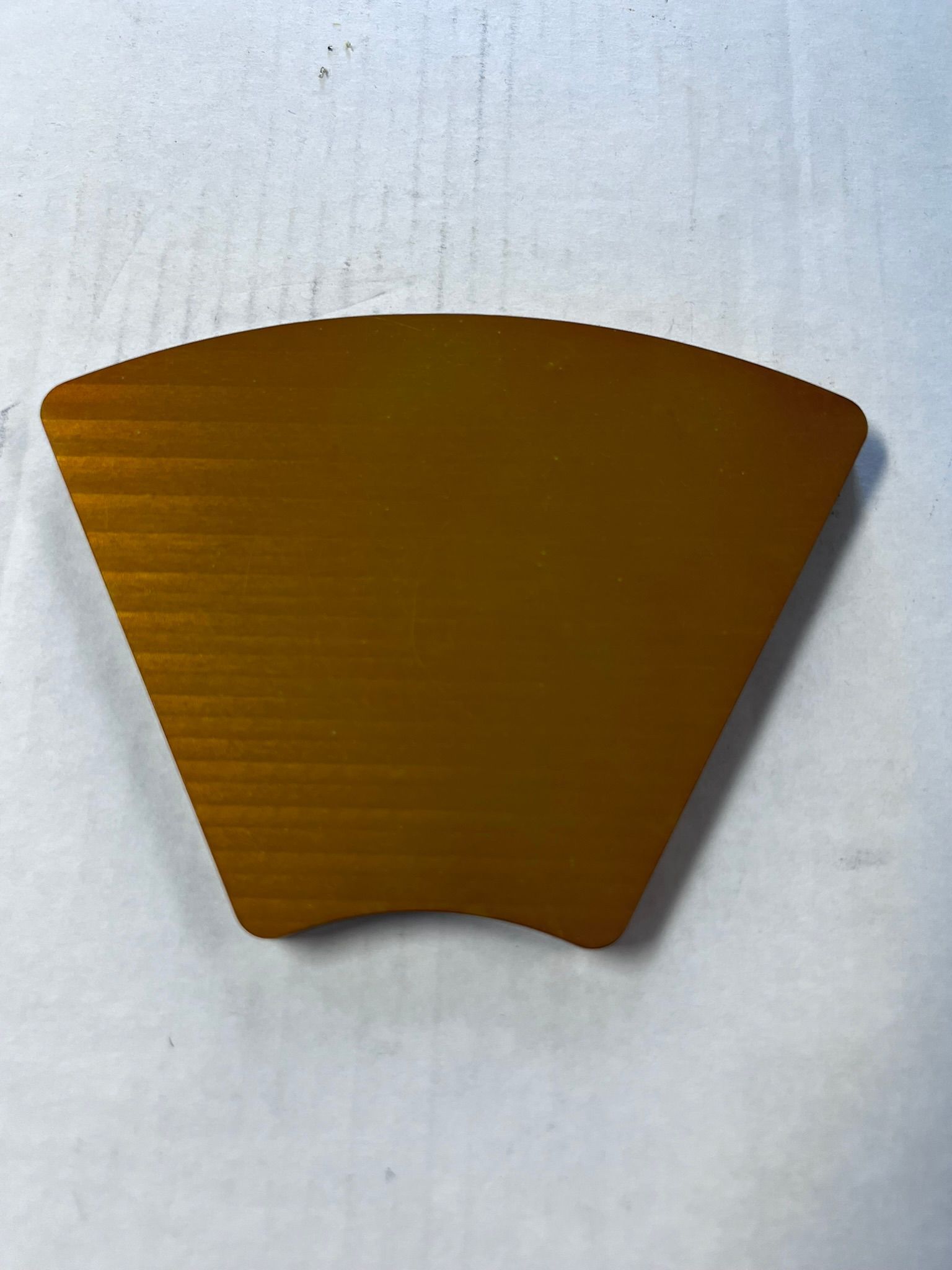 A piece of brown paper is sitting on a white surface