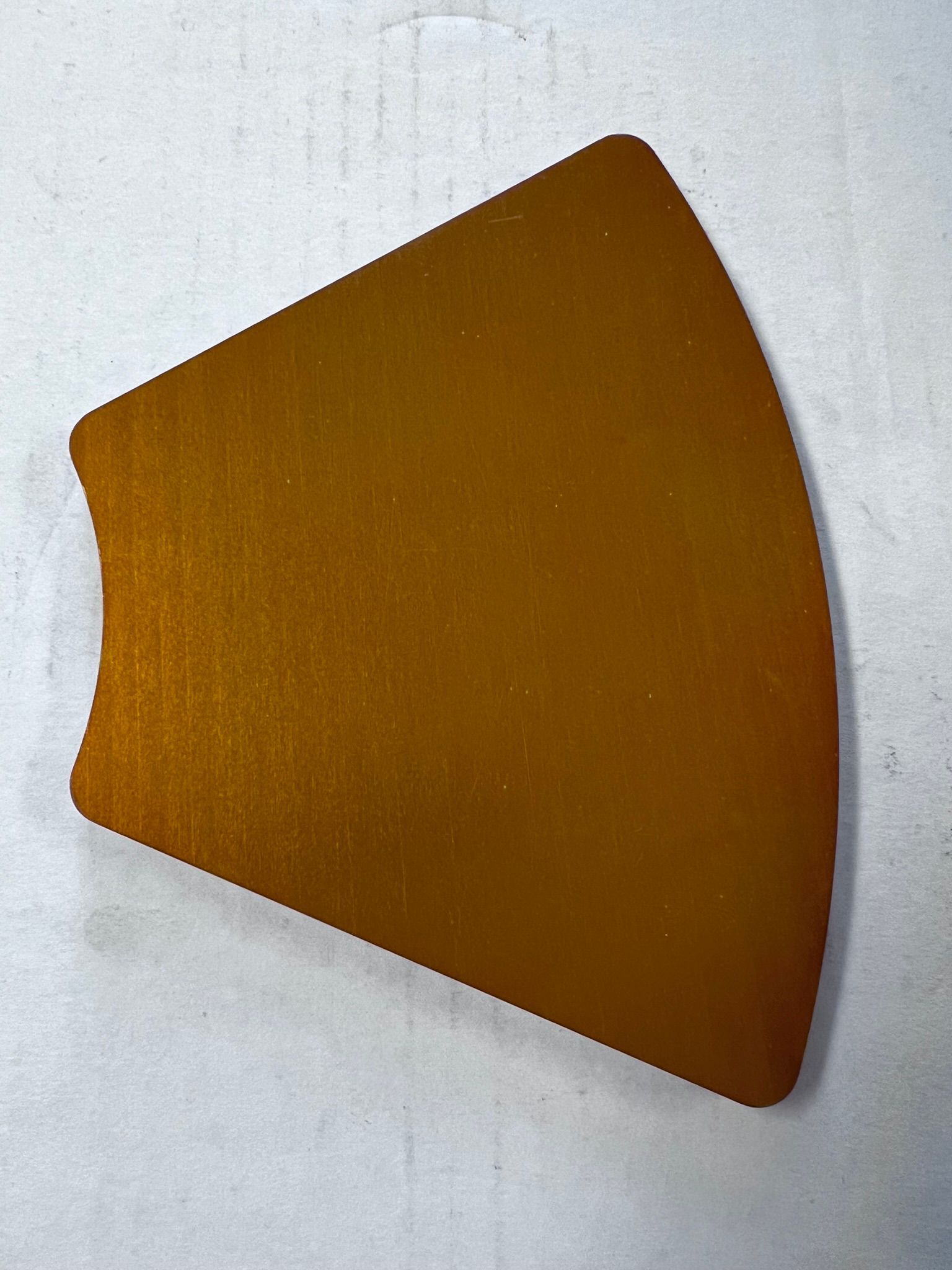 A piece of brown paper is sitting on a white surface