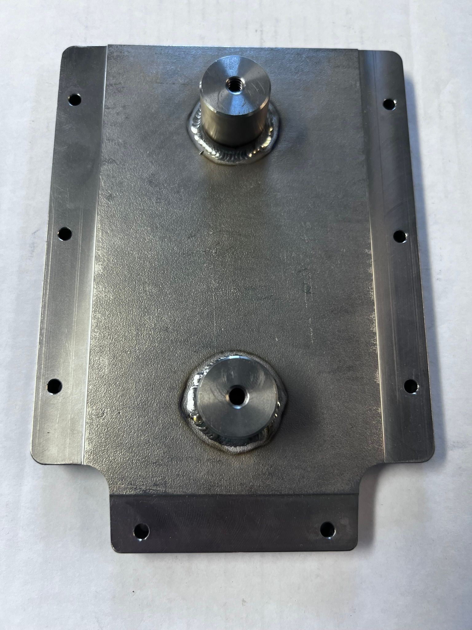 A piece of metal with two holes in it
