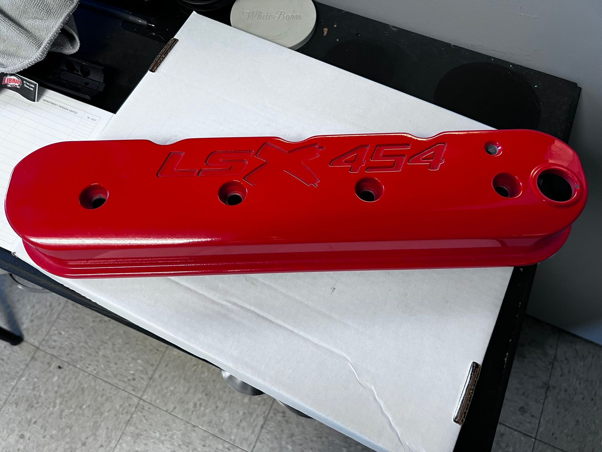 A red item on a table that says 454 on it
