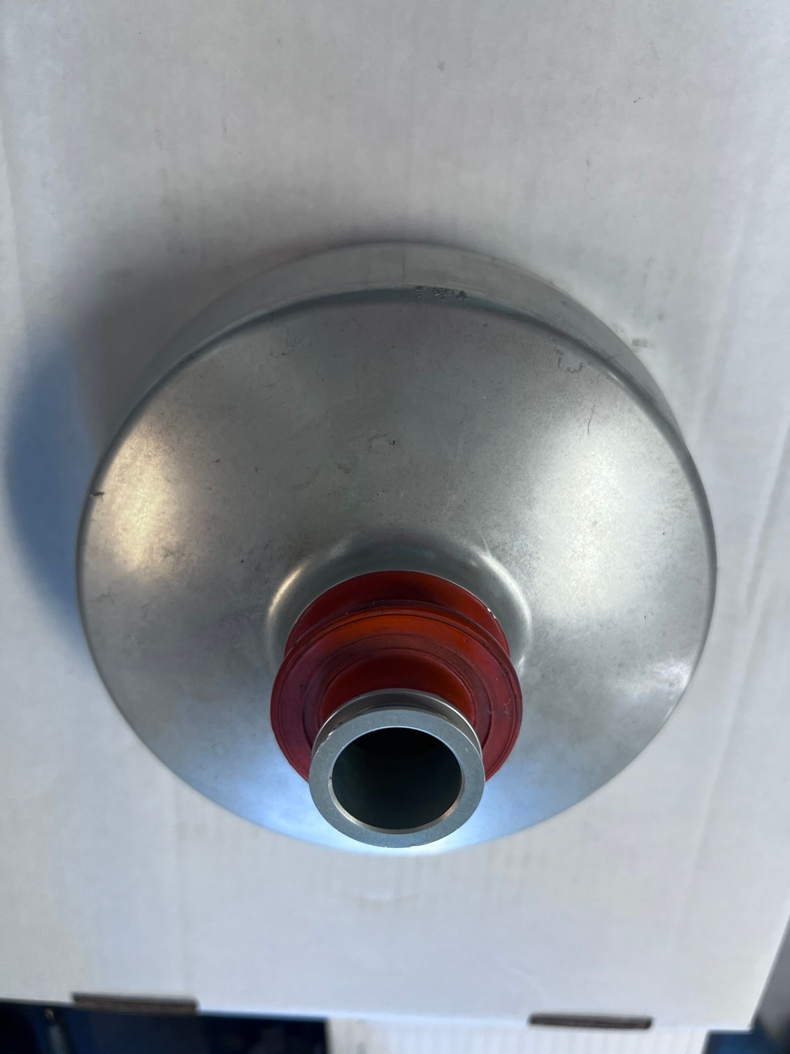 A close up of a metal object with a hole in the middle.