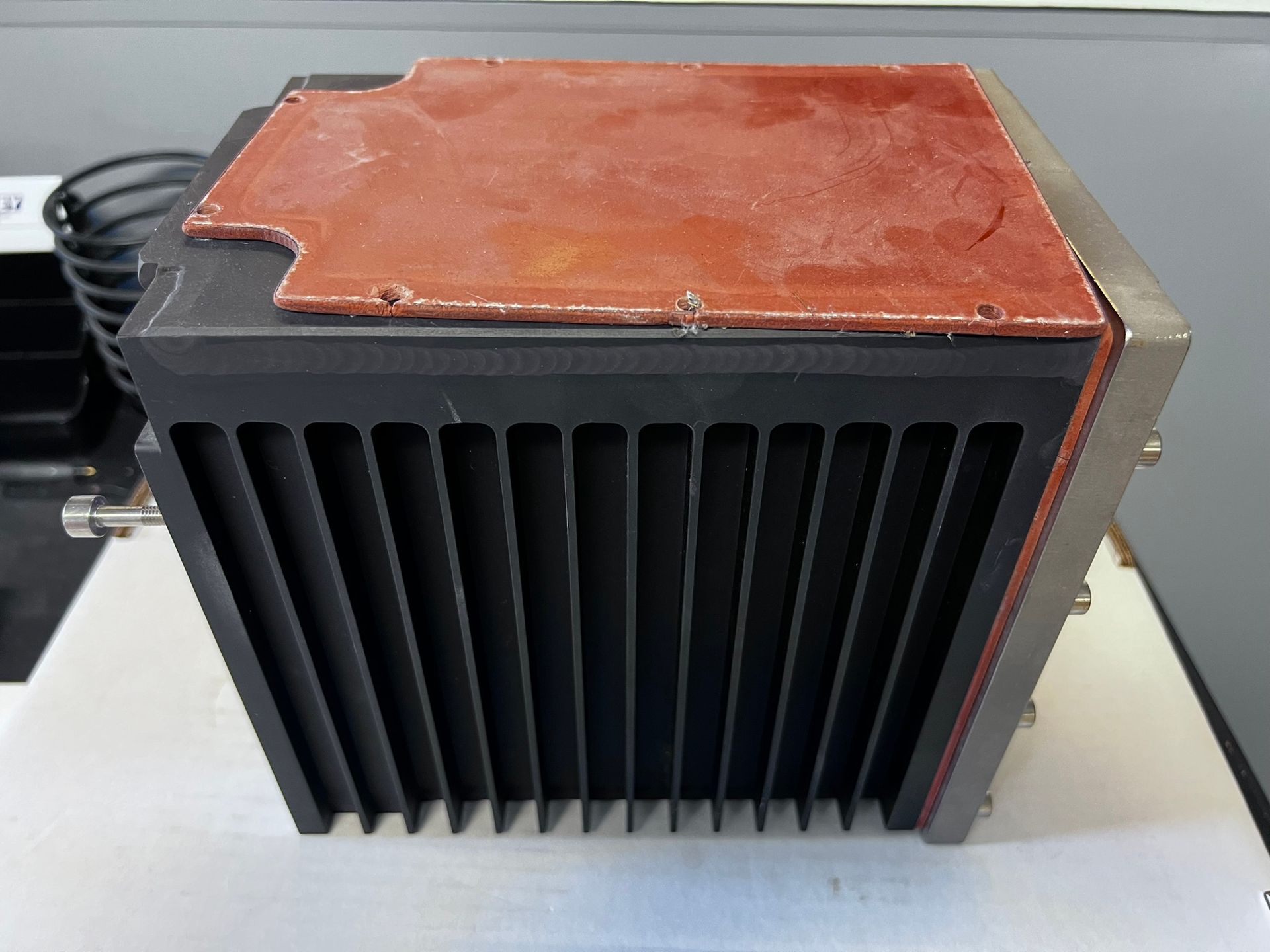 A black box with a red top is sitting on a table