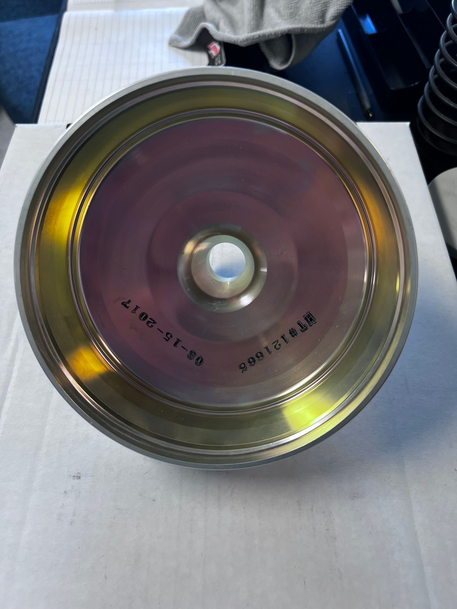 A cd with a hole in the middle is sitting on a table