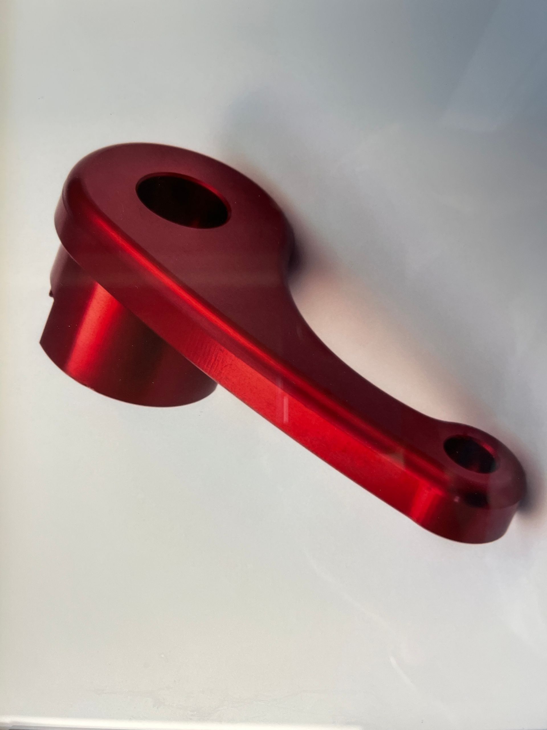A red metal object with a hole in the middle