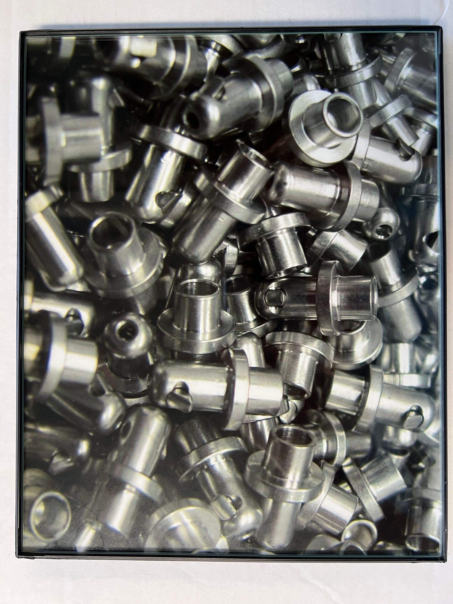A black and white photo of a pile of metal parts