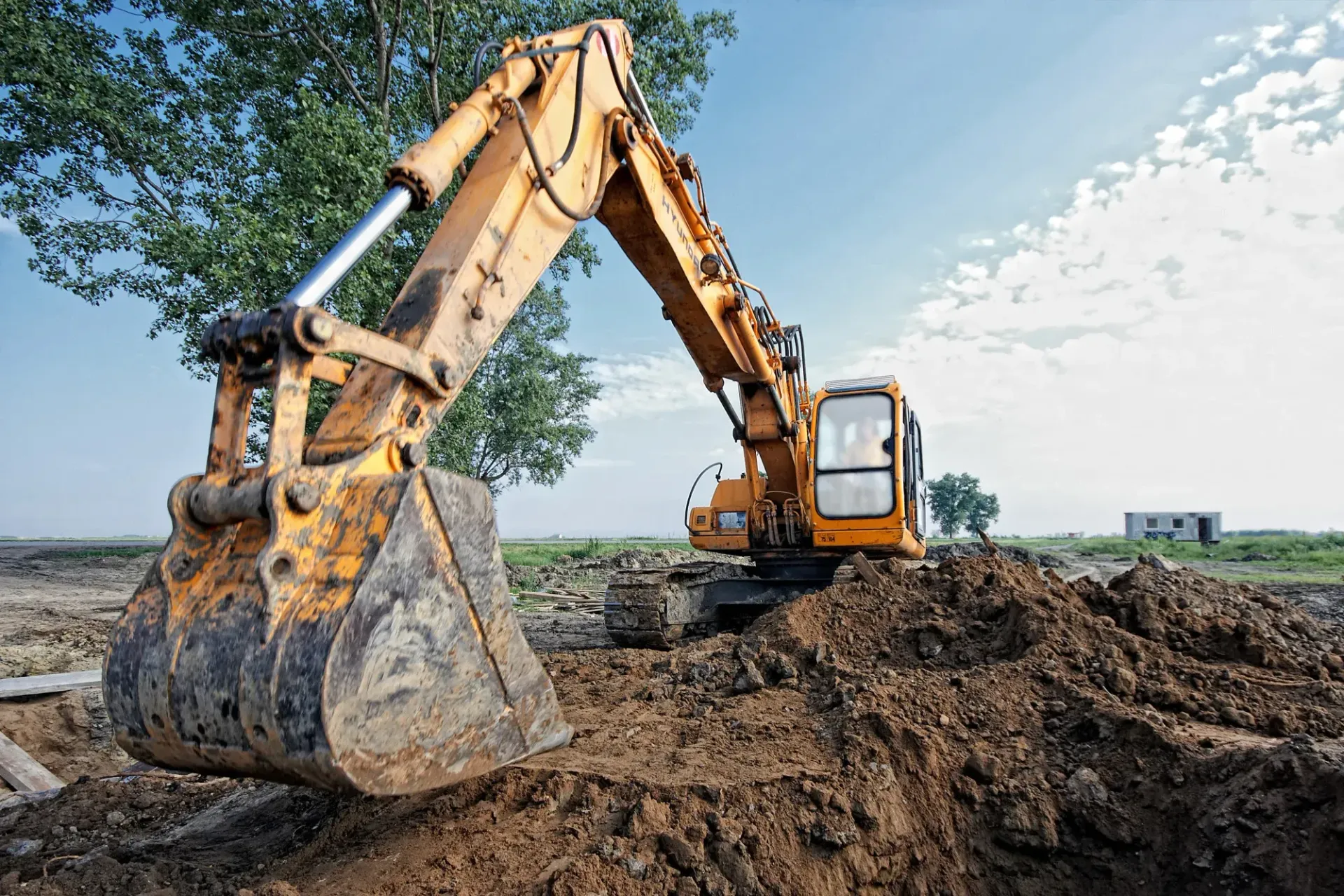 excavator working on grading Phoenix land before monsoon season