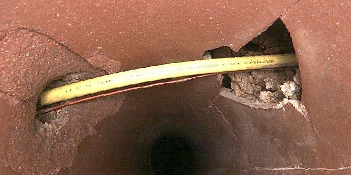 Utility locators verifying line position with potholing excavation