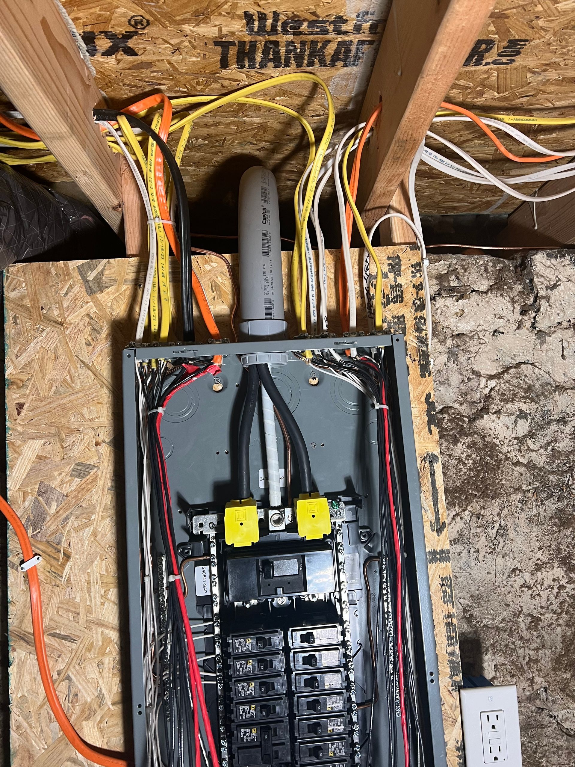A electrical box with a lot of wires coming out of it.