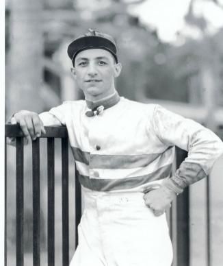 Eddie Arcaro photo jockey leaning on fence