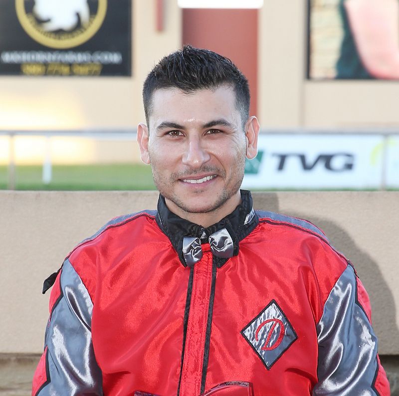 Jockey James Flores smiles for a photo at the races