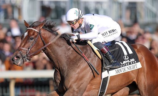 Racehorse and jockey in white silks galloping at full speed on a track