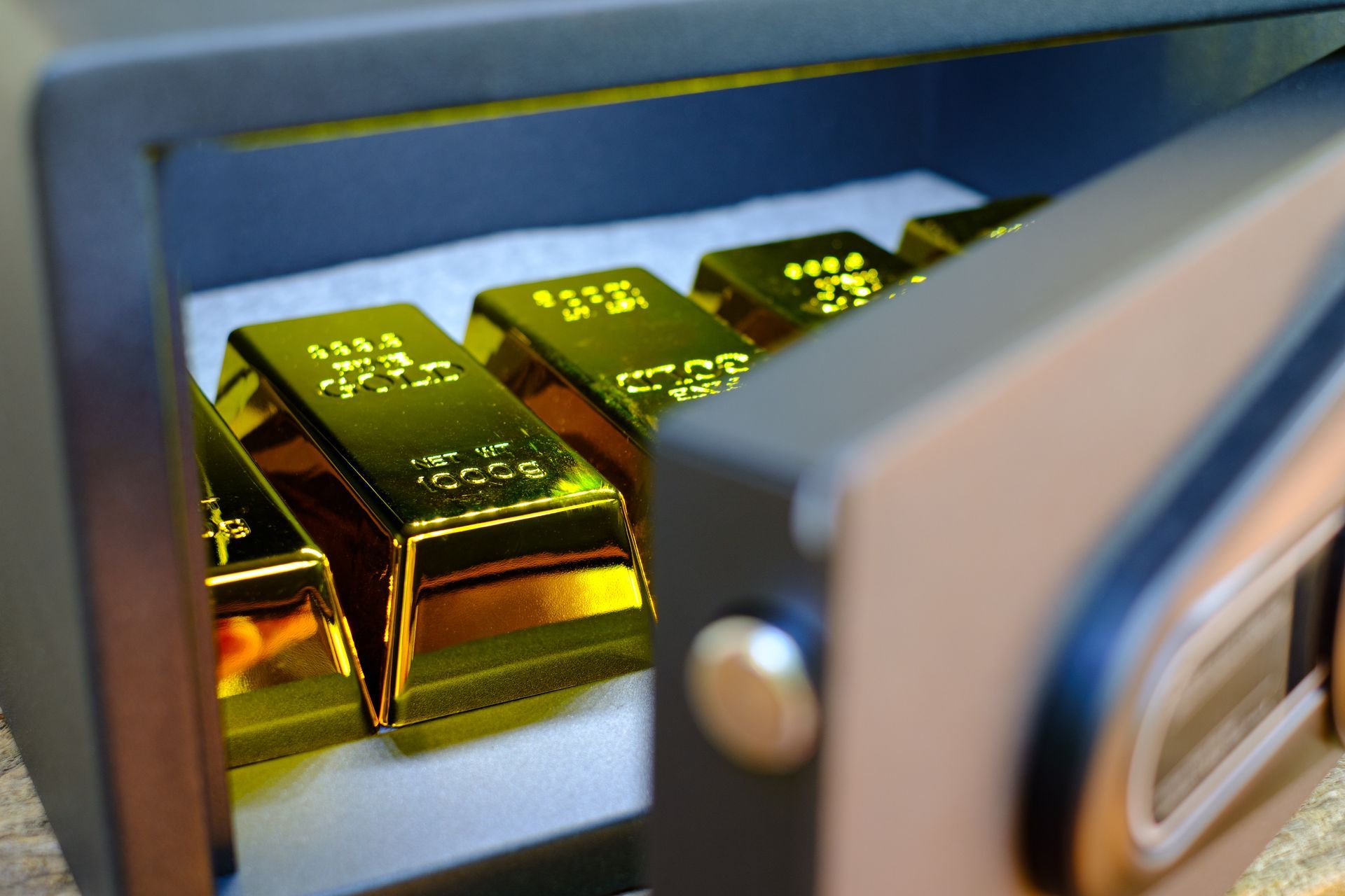 Open safe with gold bars inside