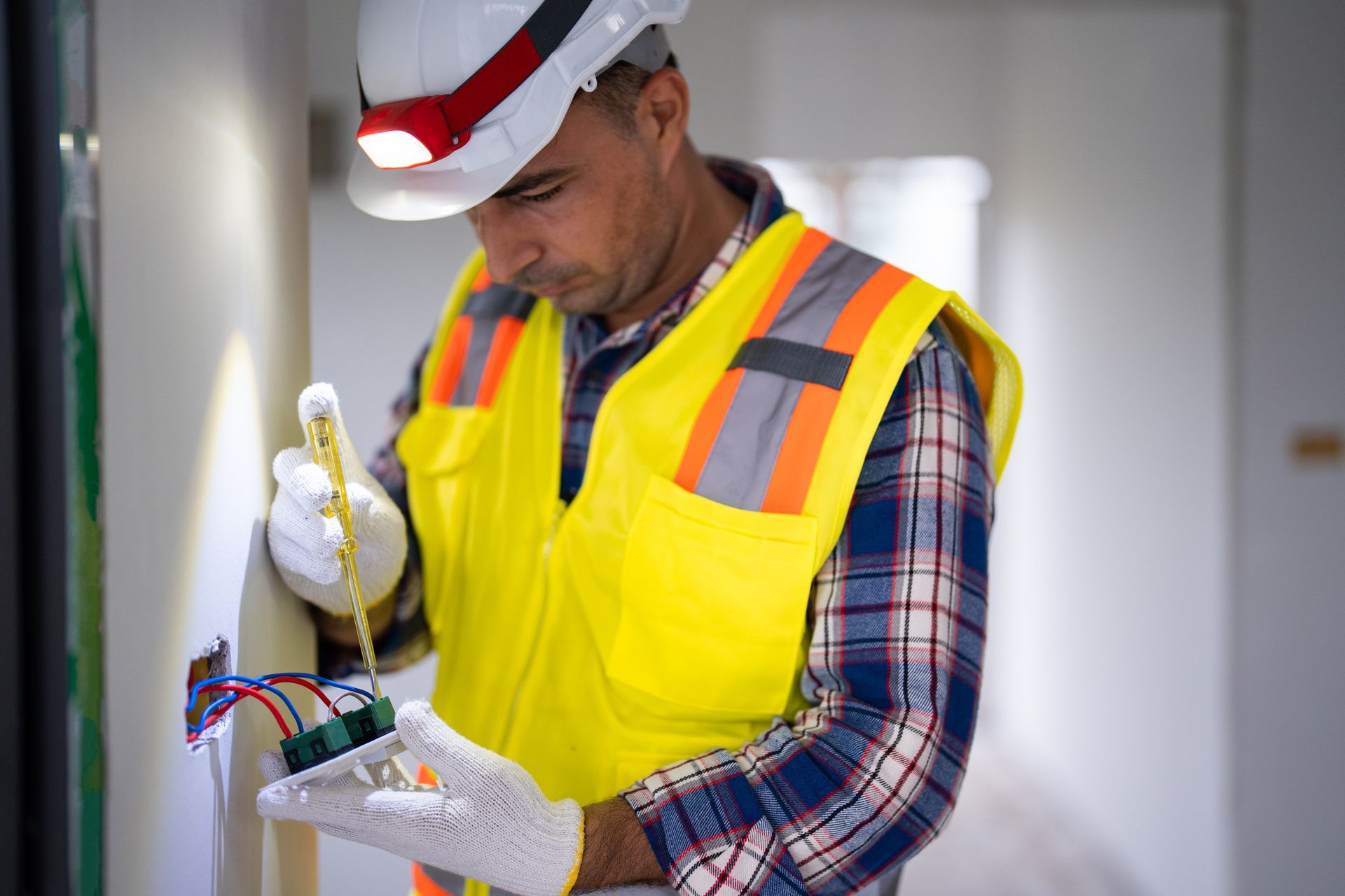 An electrician prepares the installation of electrical wiring.