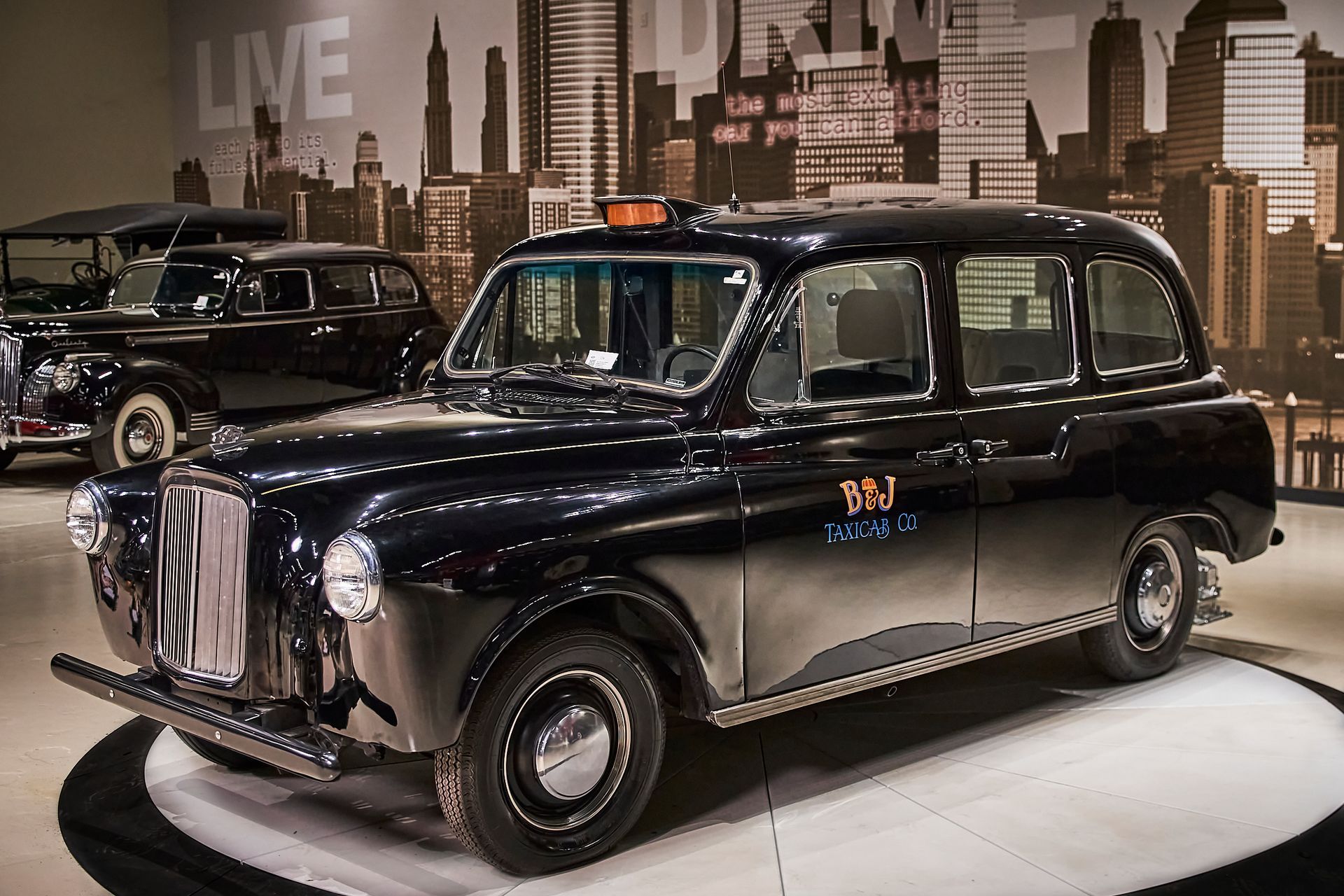 A black taxi cab with the number 997 on the side