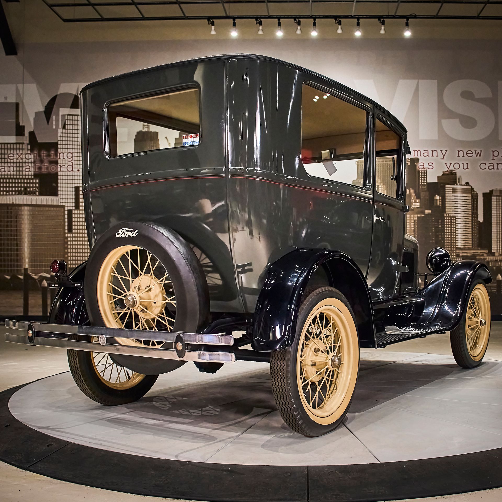 An old ford car is on display in a museum