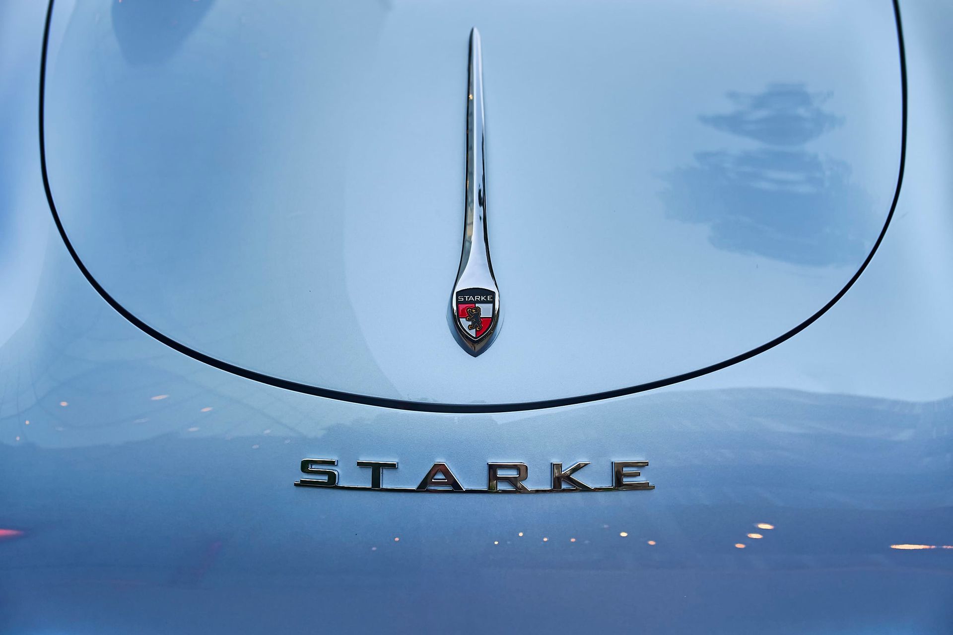 Close-up of a light blue car's rear with the word