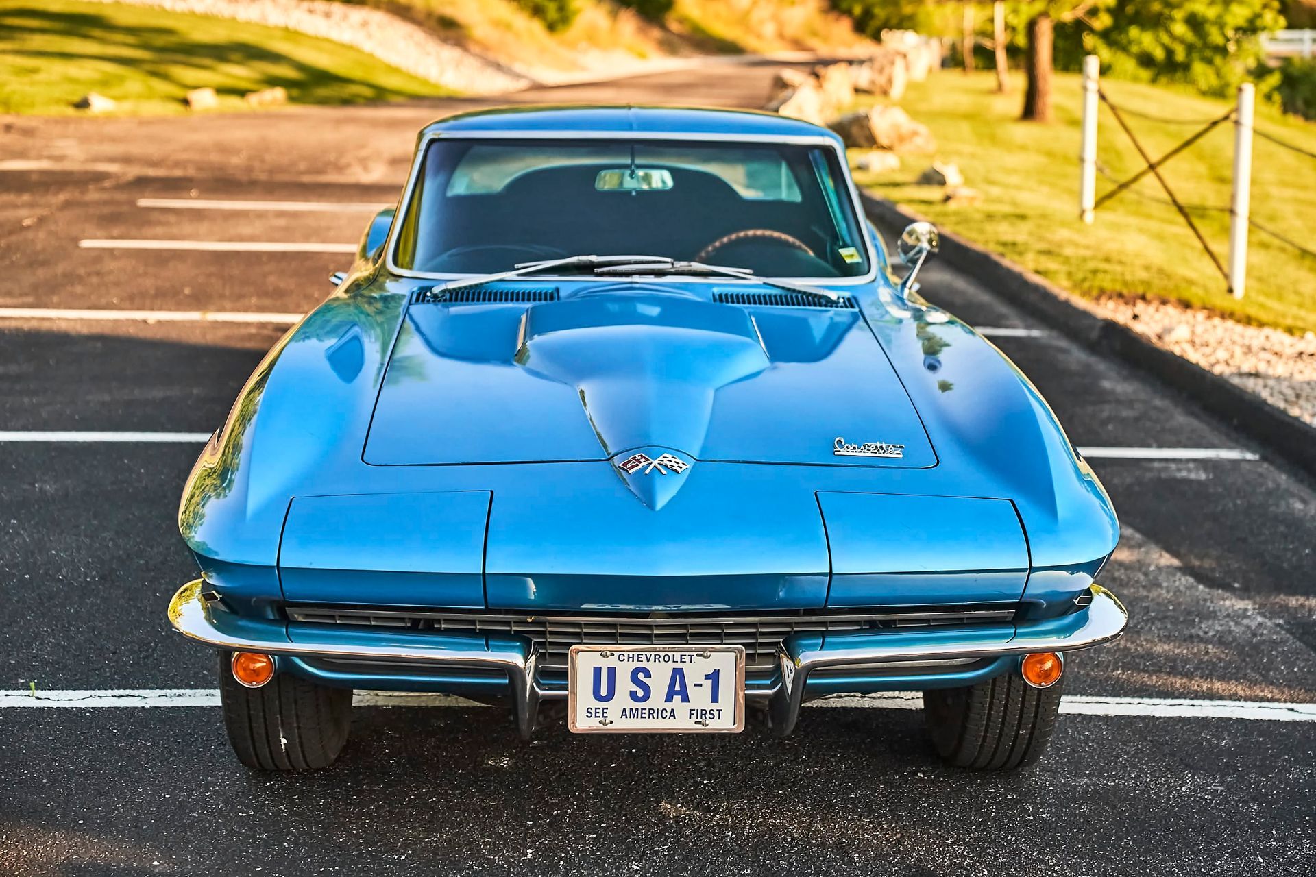 Blue classic Chevrolet Corvette parked in a lot with a 