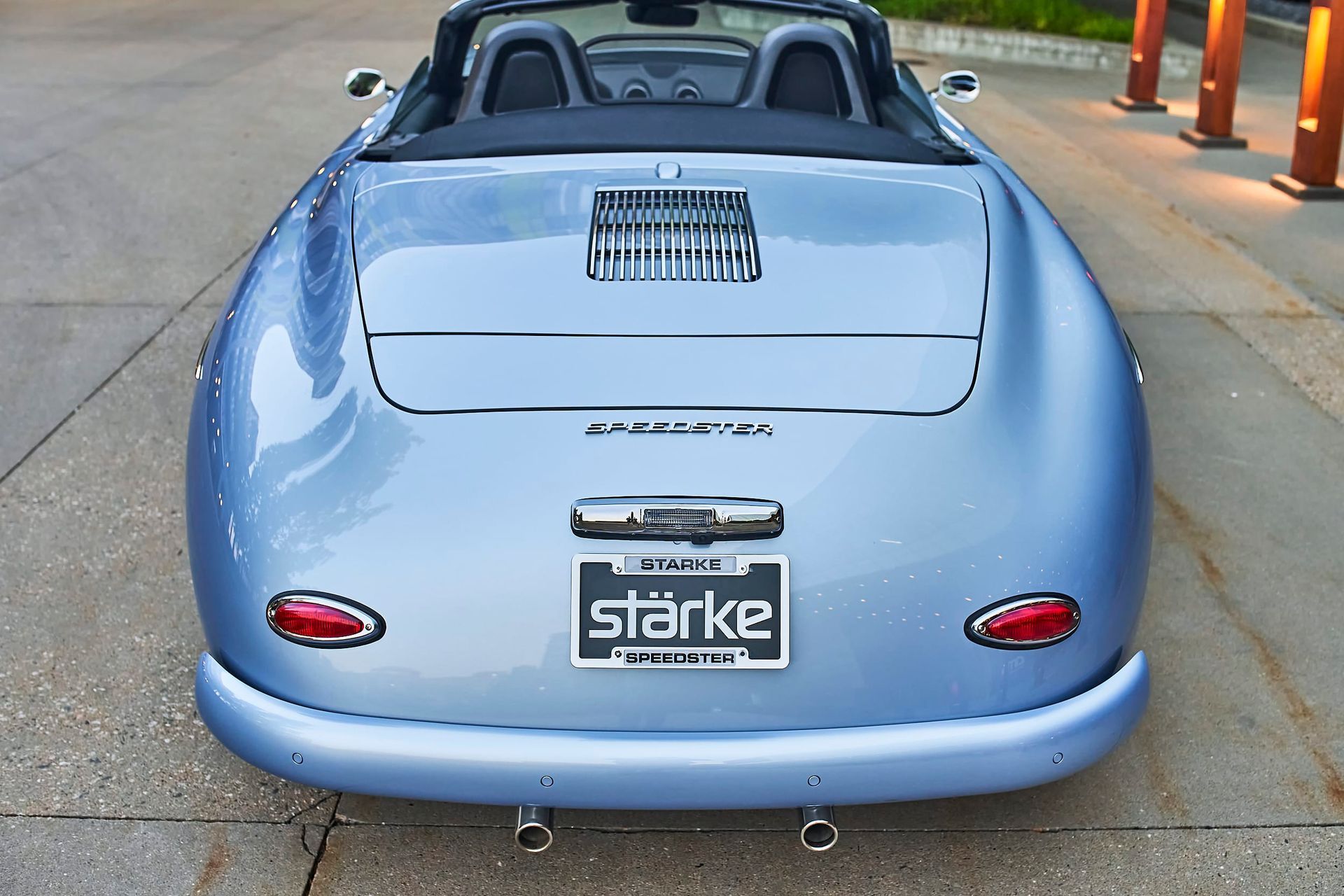 Rear view of a light blue vintage convertible car with the word