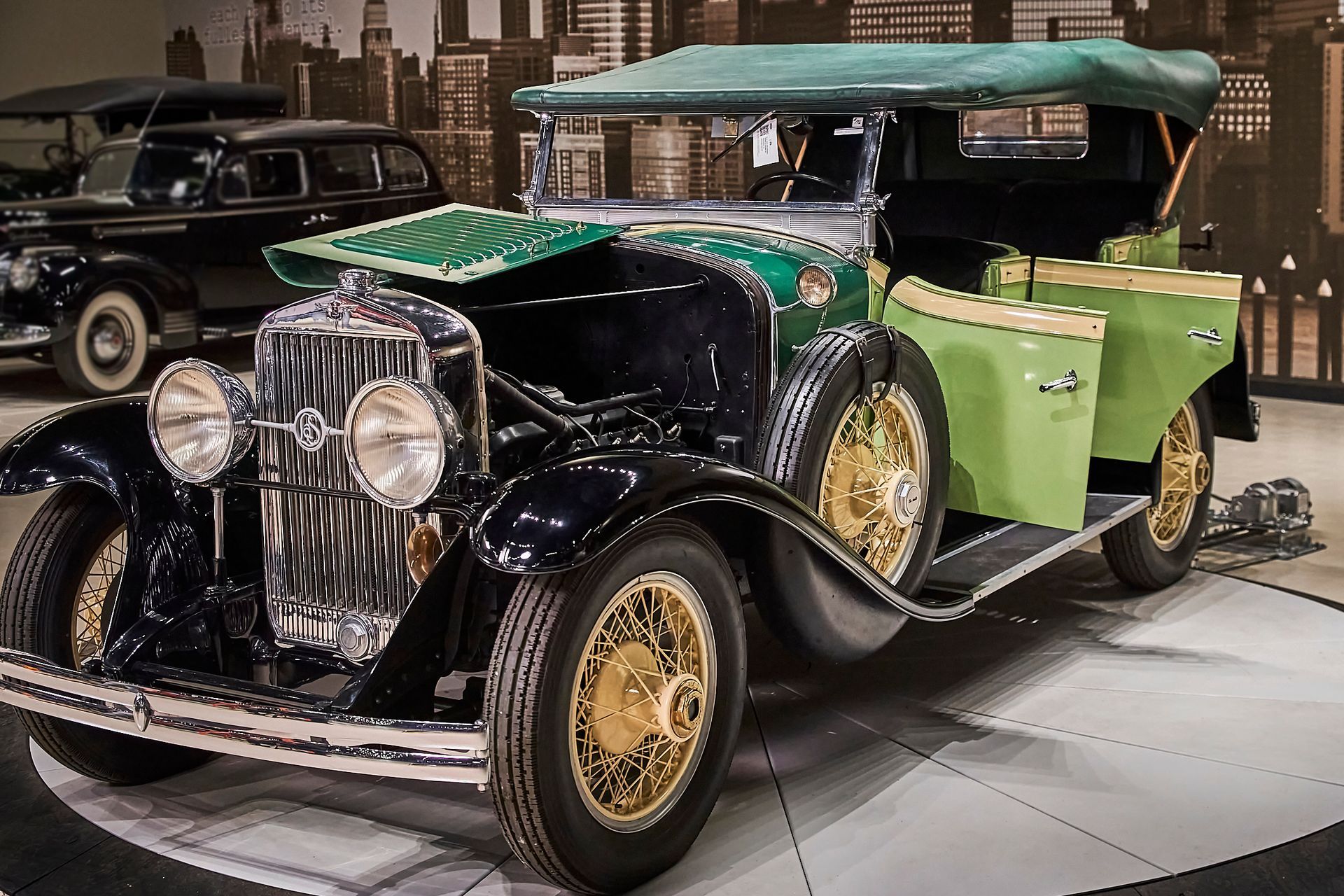An old black and green car with a green canopy