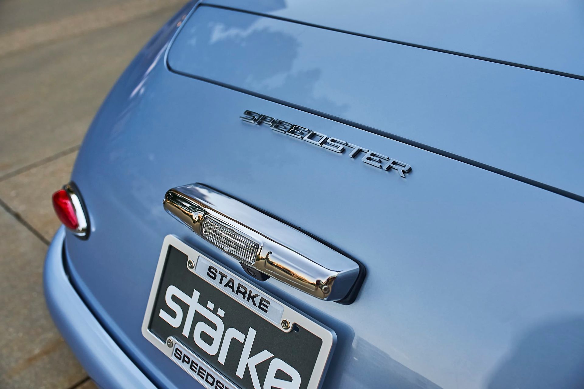 Close-up of a light blue Porsche Speedster's rear, displaying the