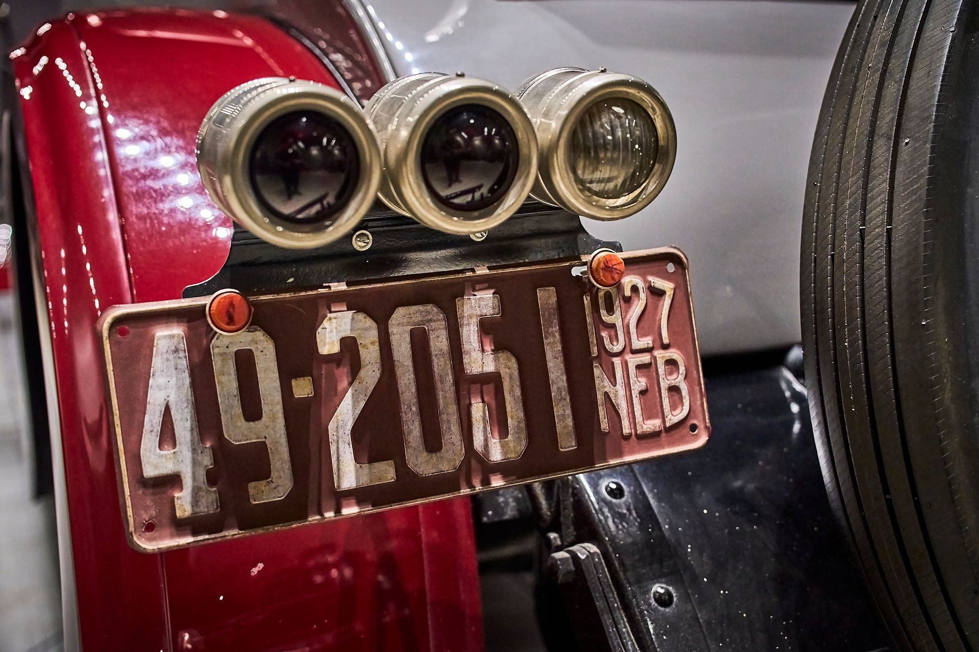 A red car with a license plate that says 49-2051 heb