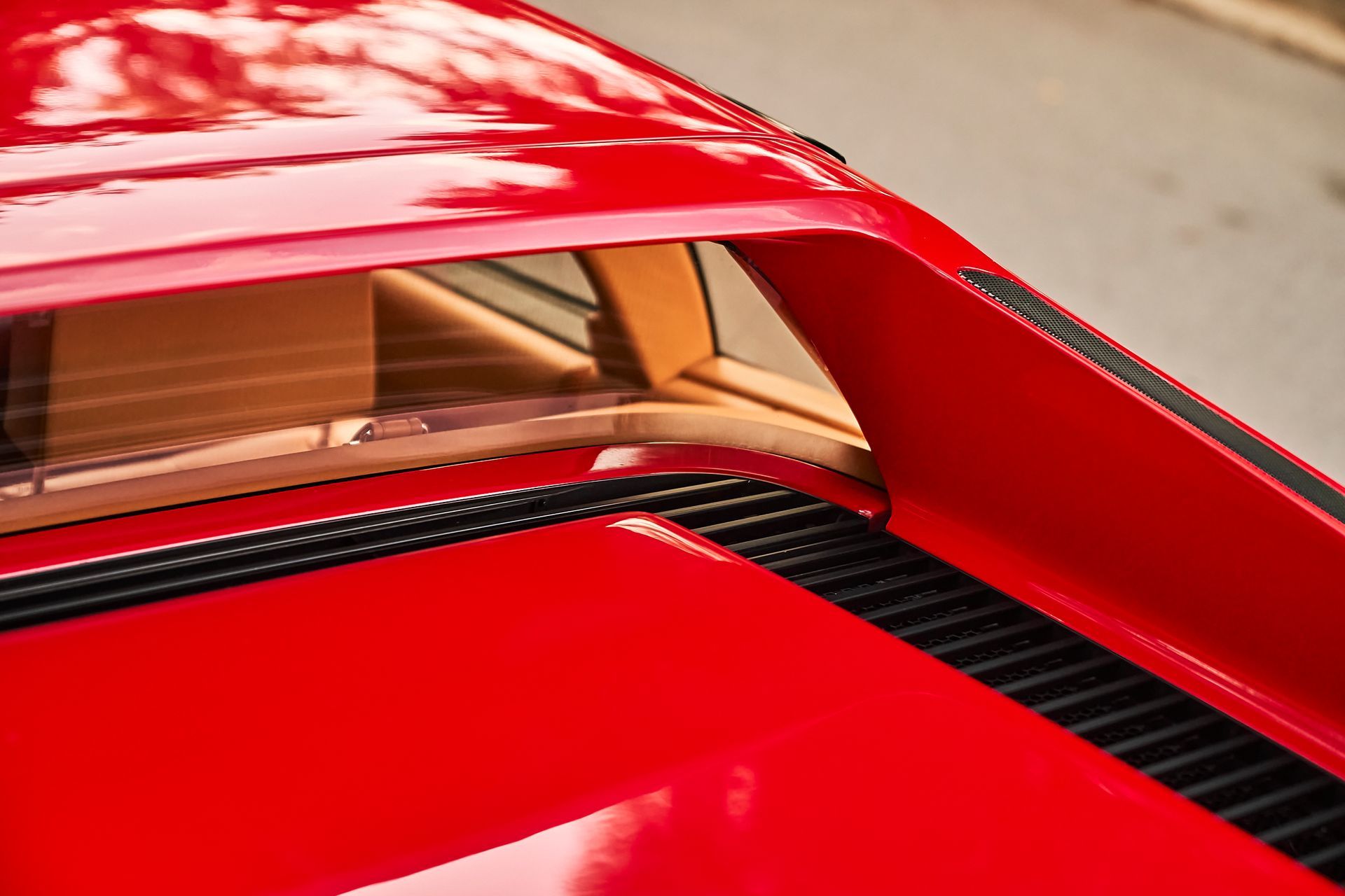 A close up of the hood of a red car.