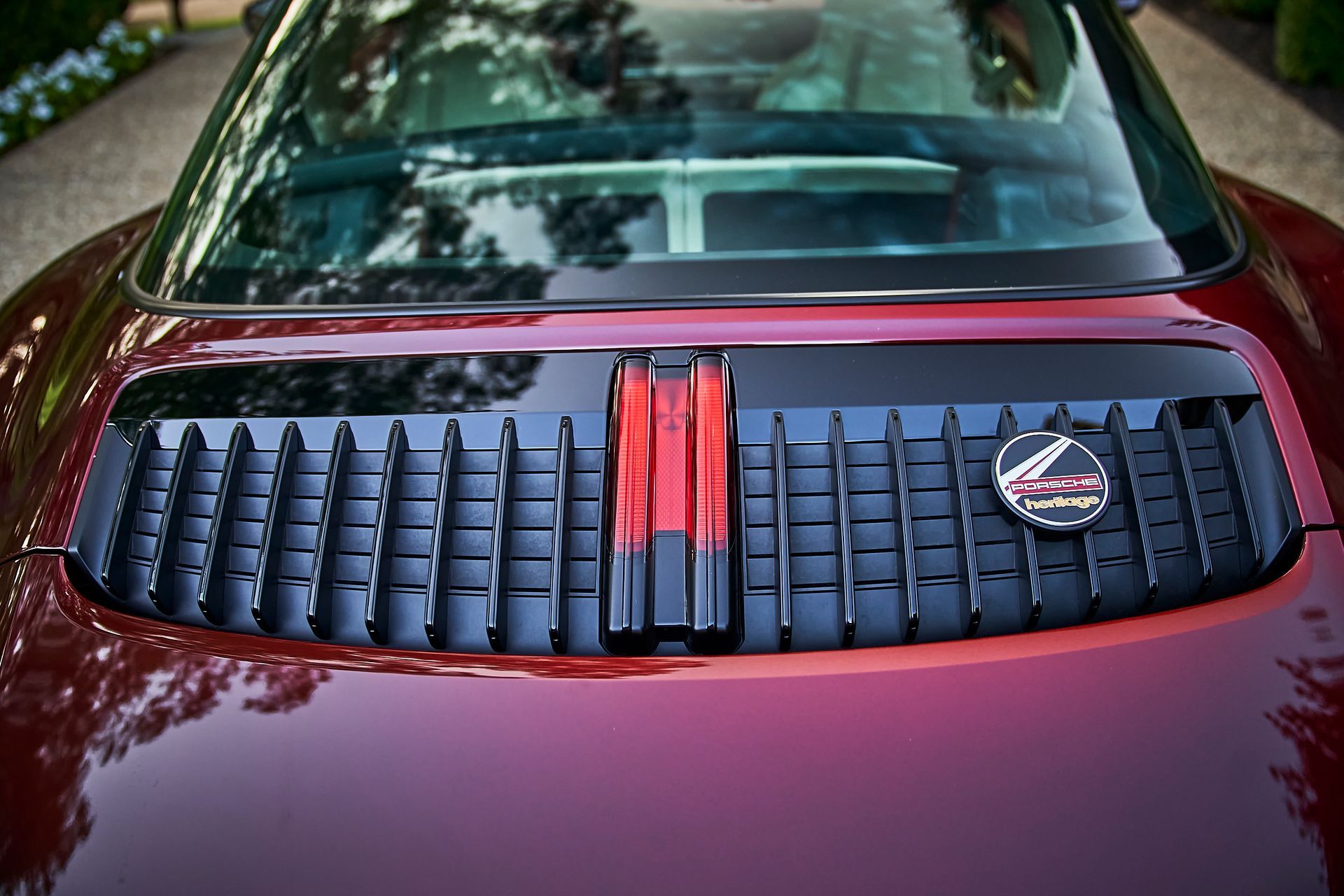 A close up of the hood of a red sports car.