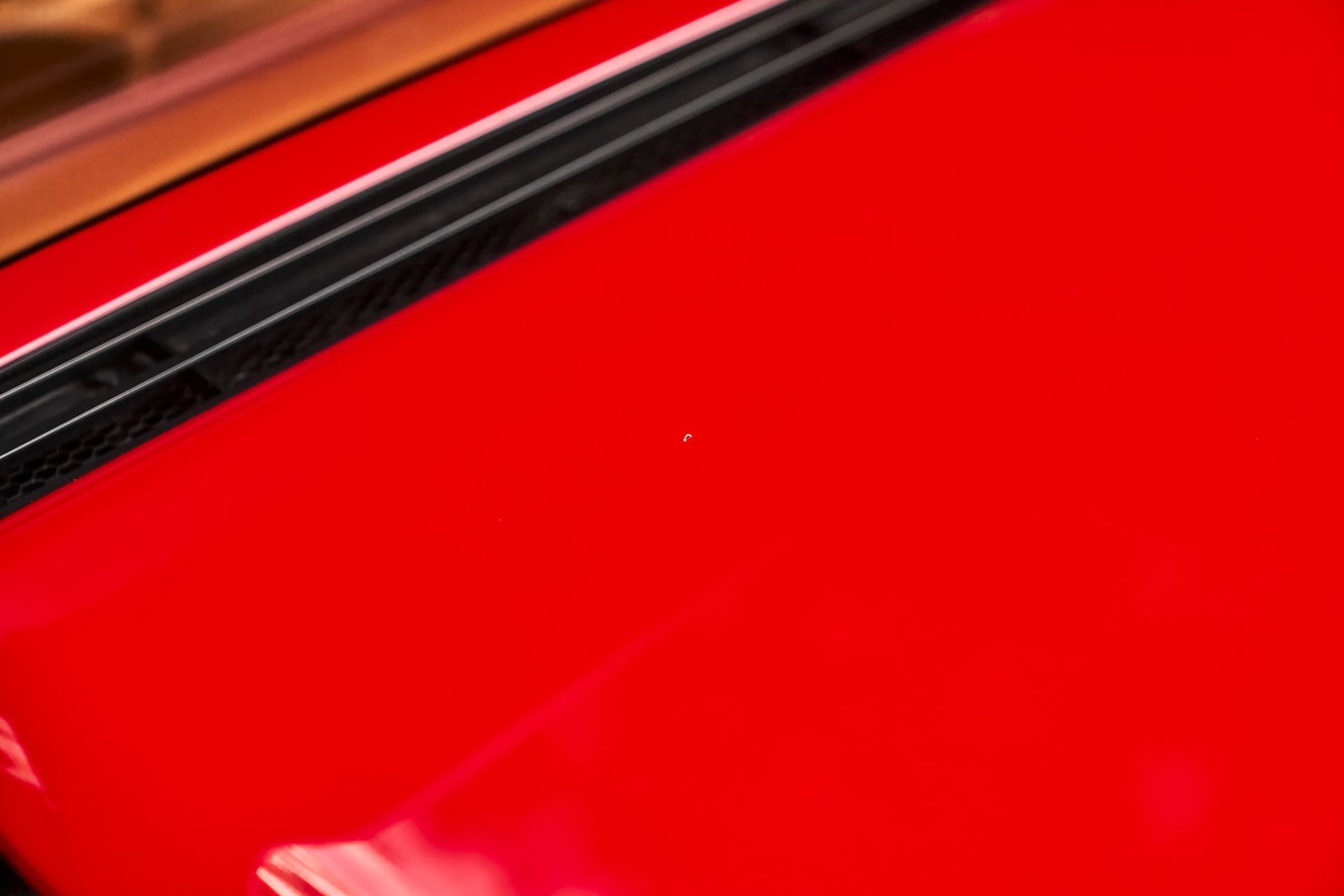 A close up of a red suitcase with a black trim.