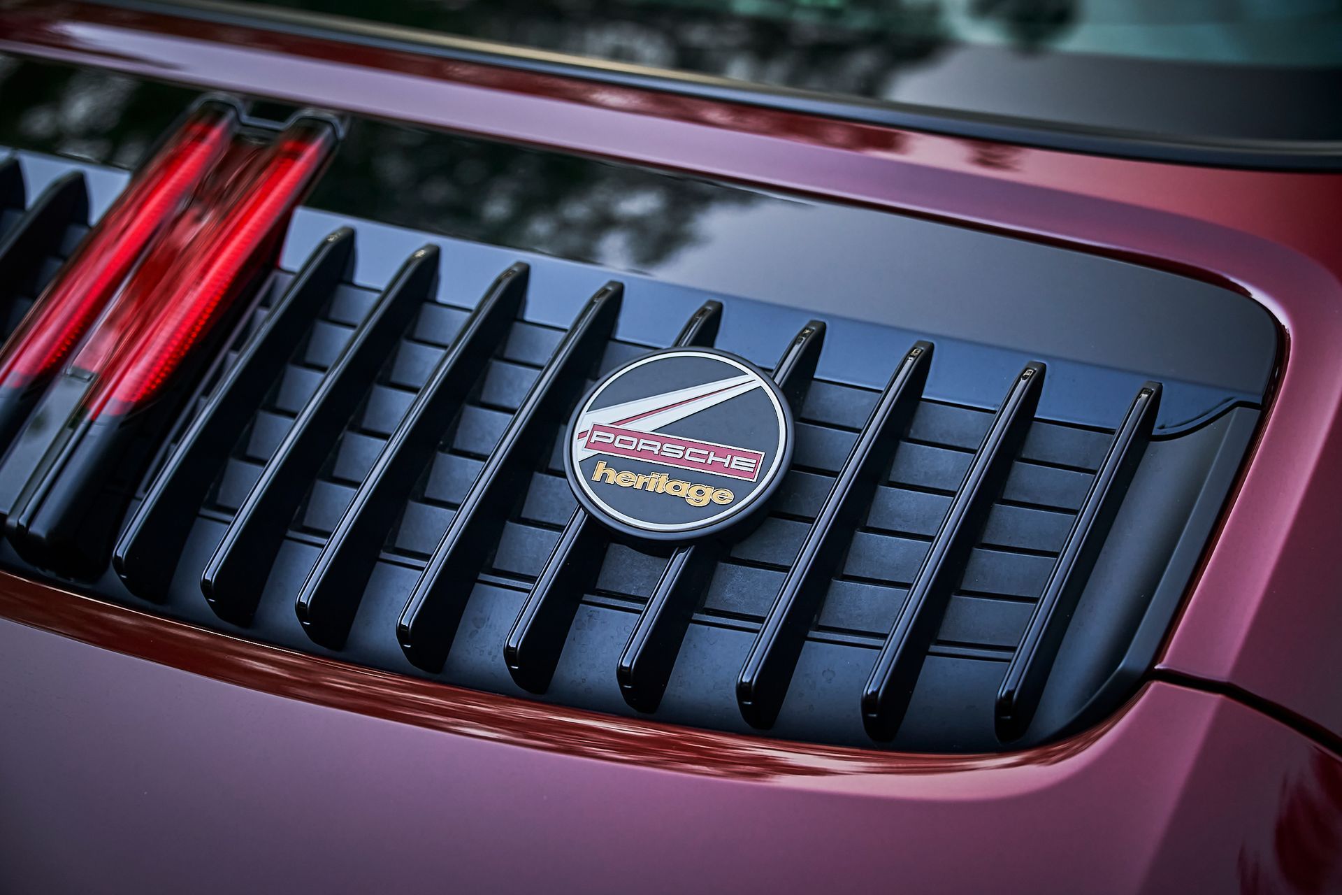A close up of the grille of a red car