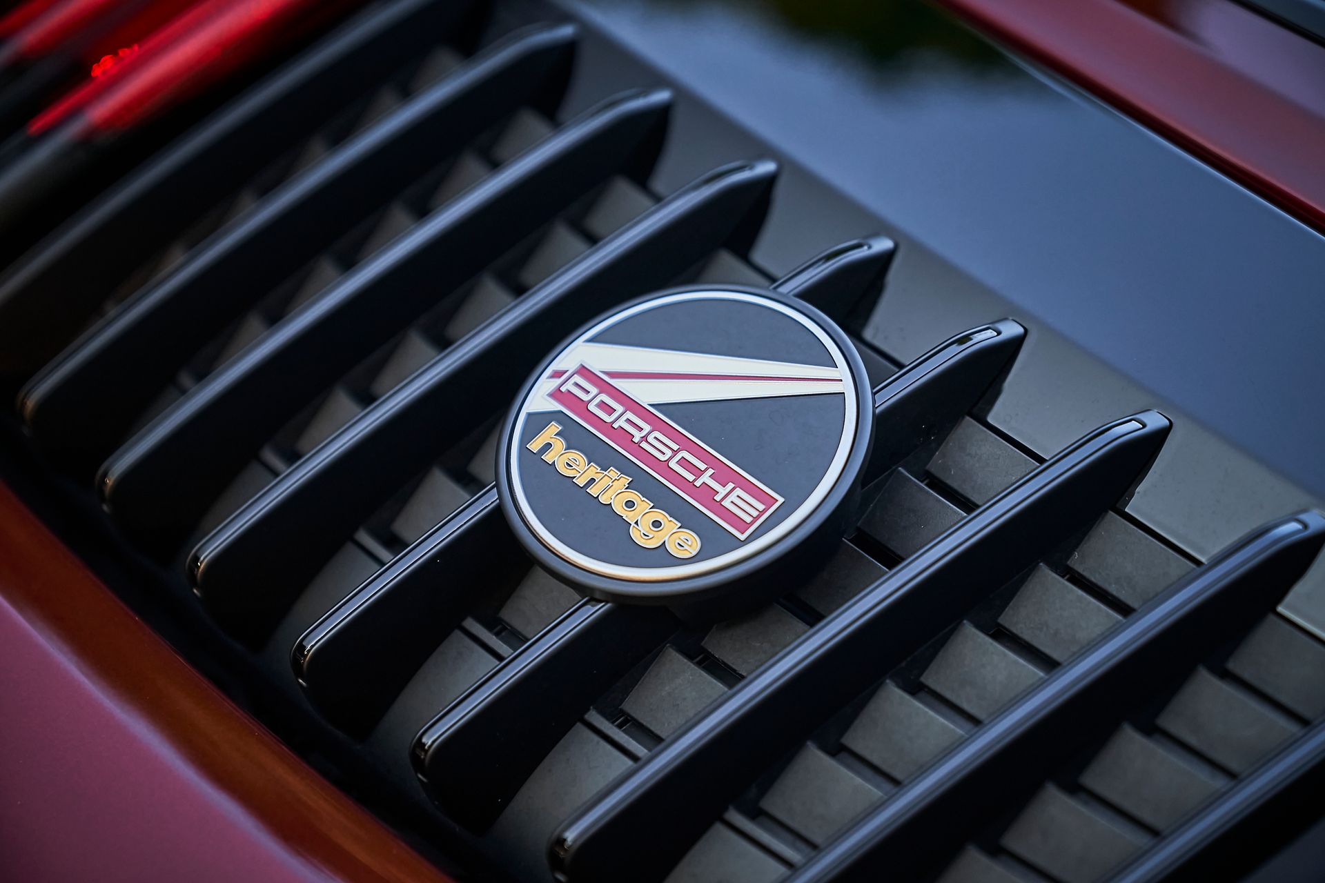 A close up of a porsche heritage emblem on a car