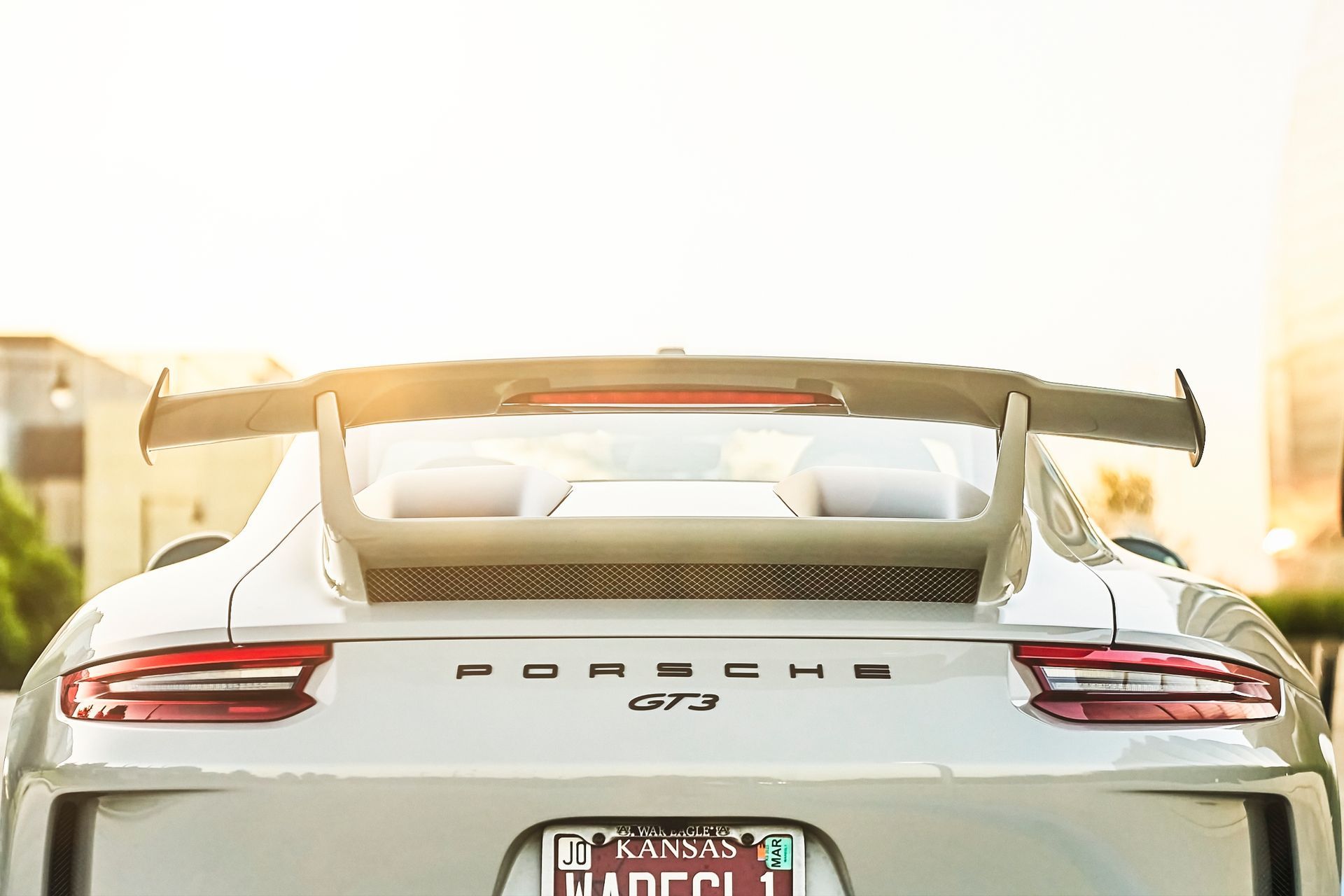 The rear end of a white porsche 911 gt3 rs with a spoiler.