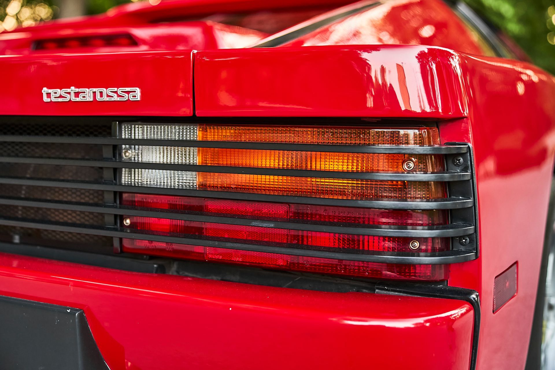 A close up of a red car 's tail light.