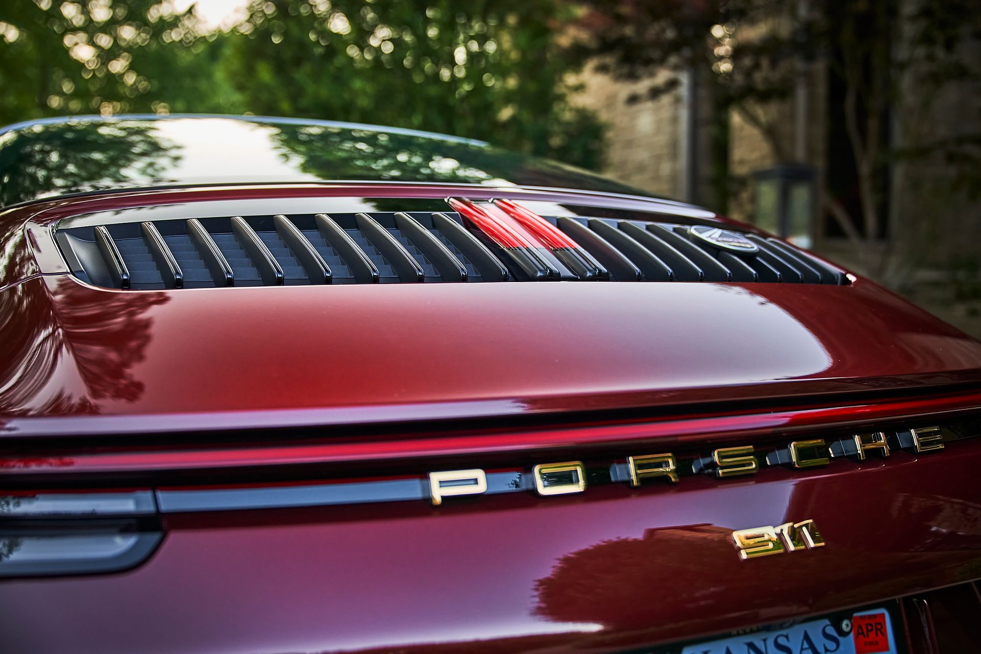The rear end of a red porsche 911 is shown.
