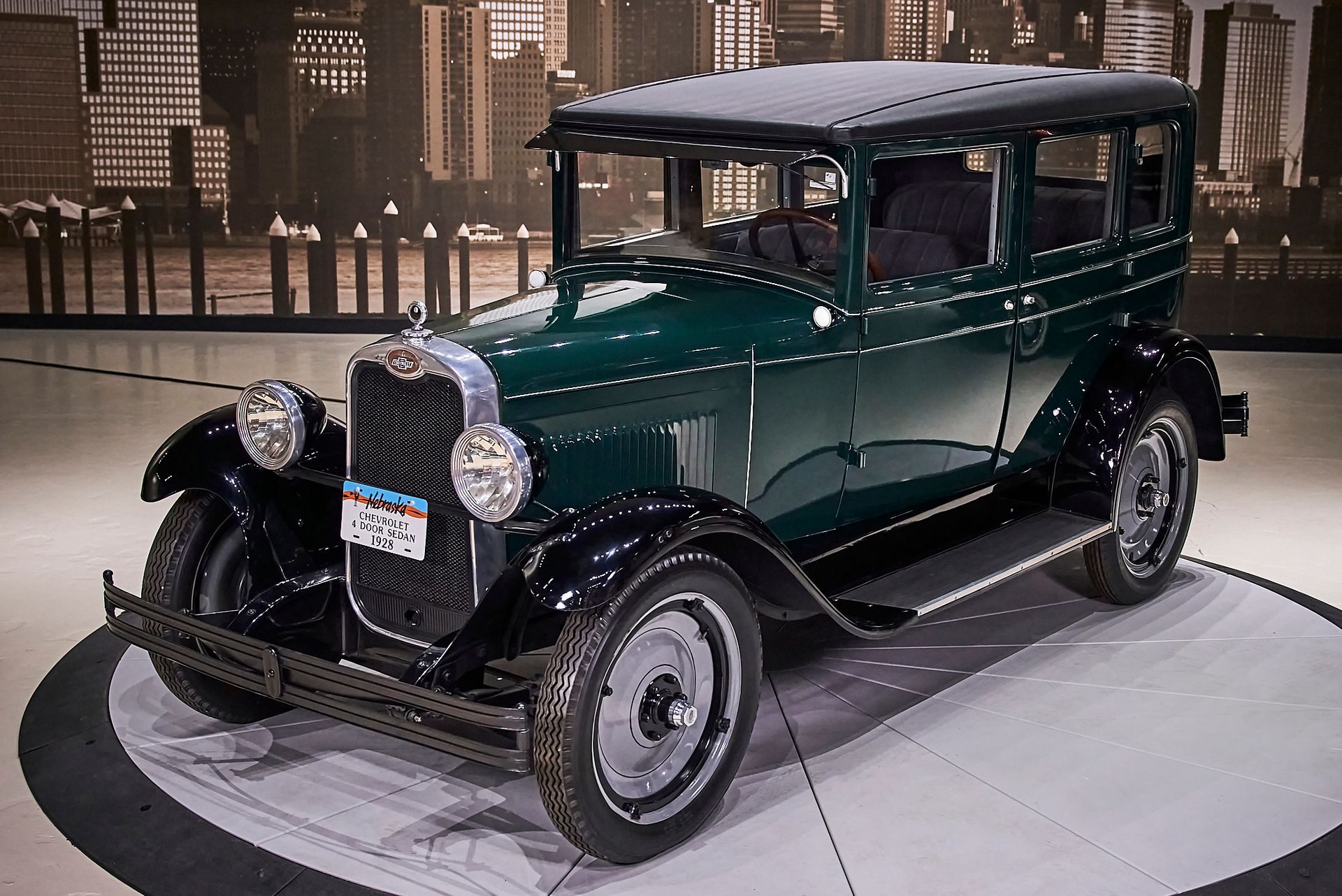 An old green car with a license plate that says nc on it