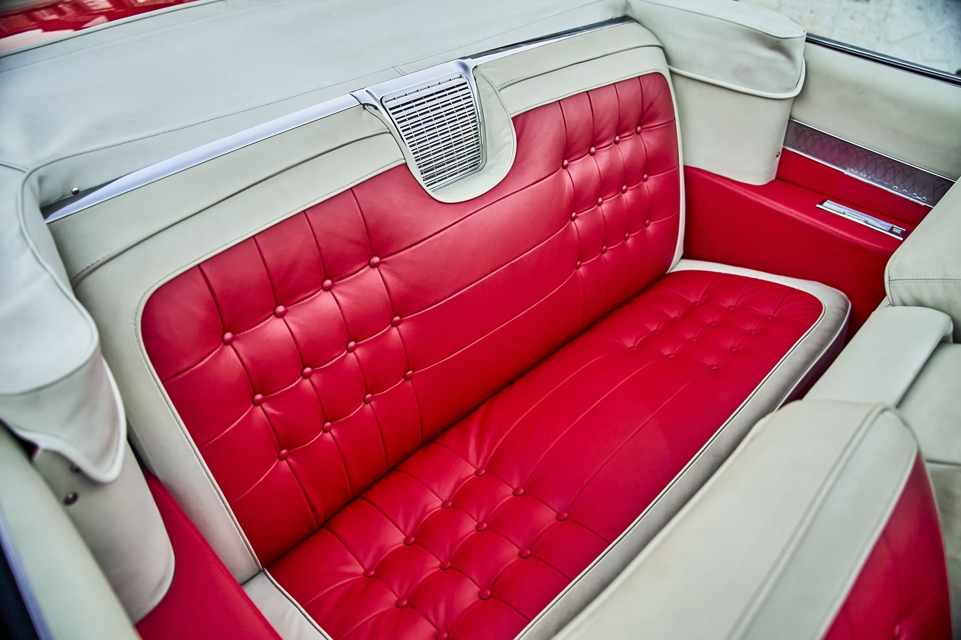 A red and white couch in the back of a car