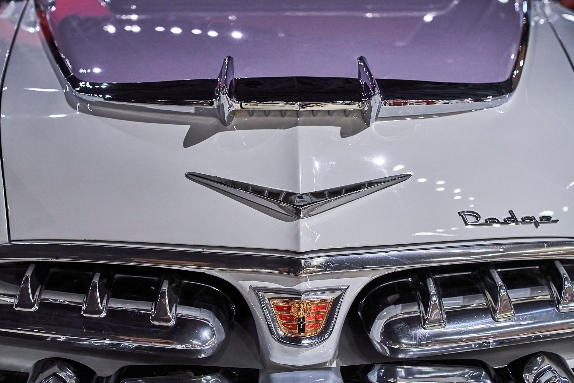 A white dodge car with the hood open