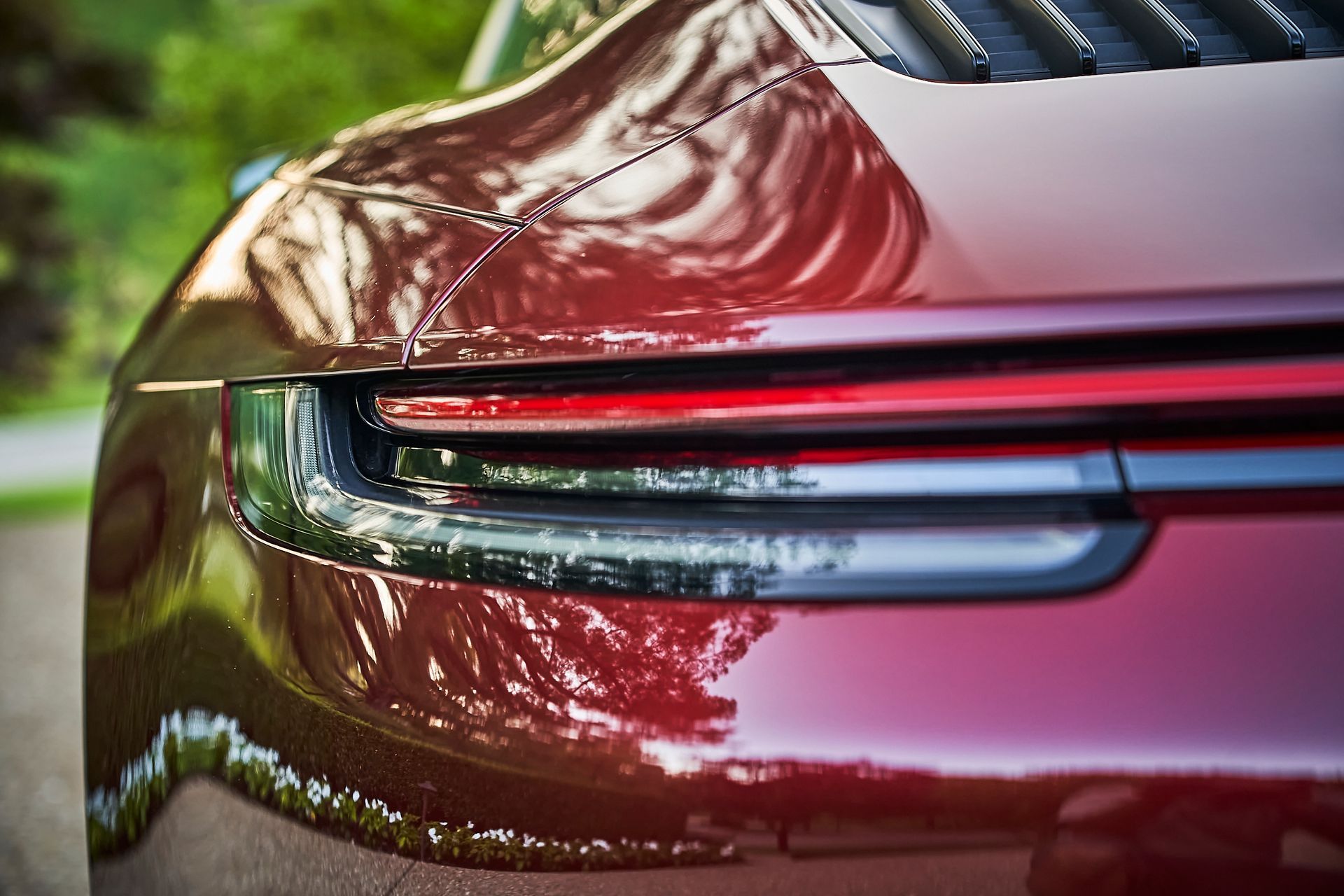 A close up of the rear end of a red sports car.