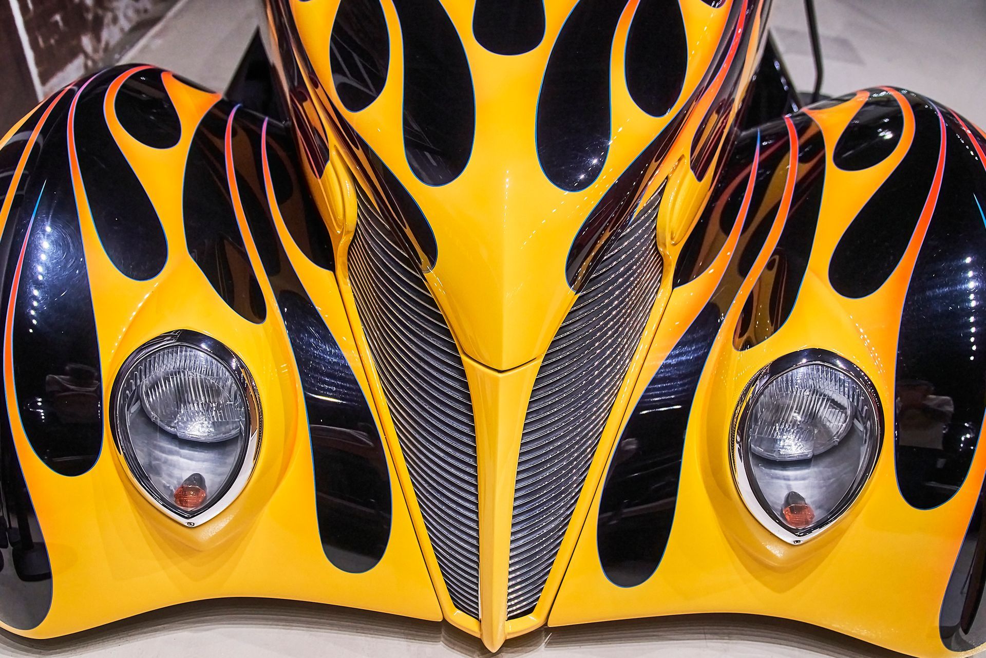 A yellow and black car with flames painted on it